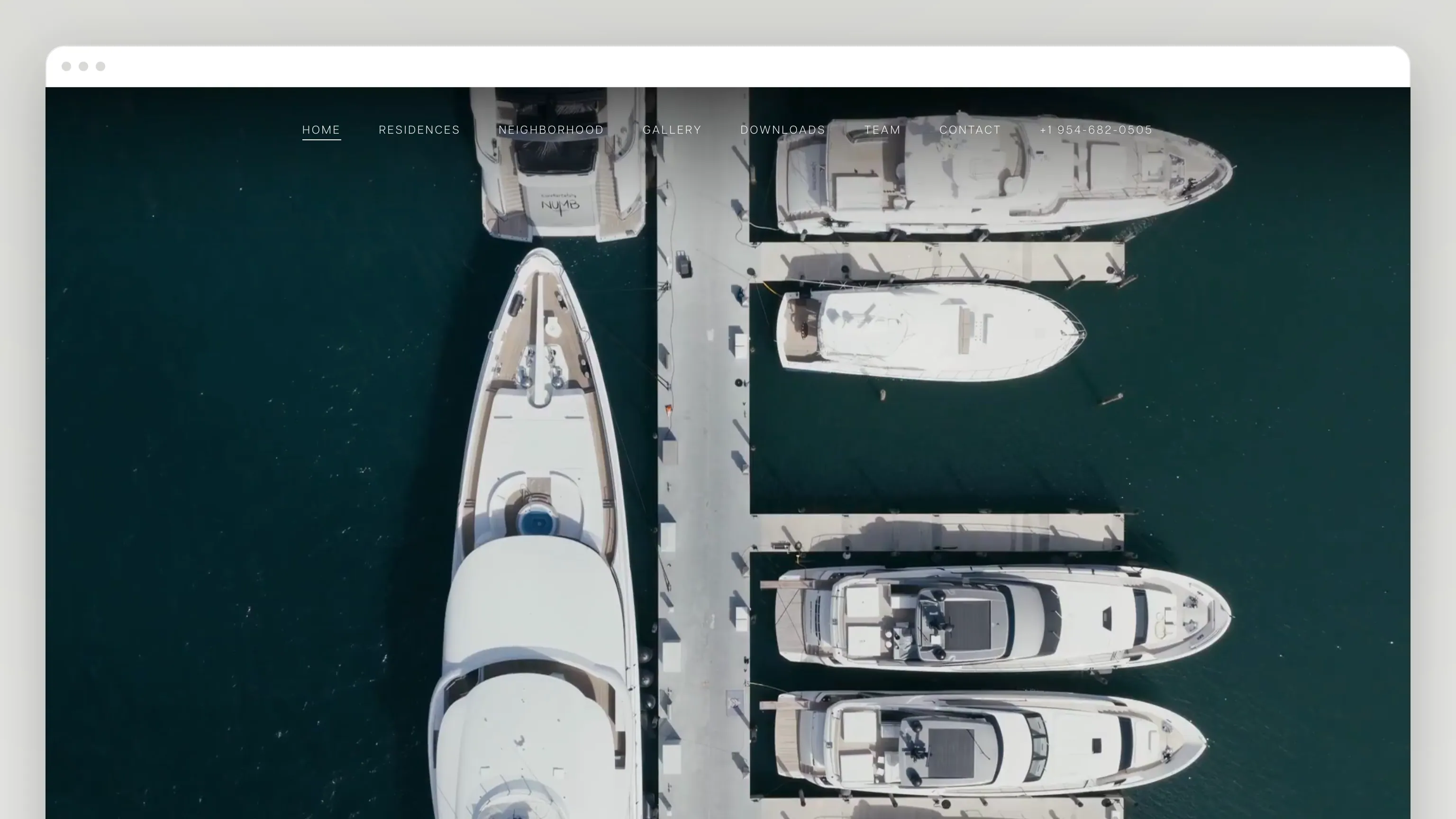 The Selva House home page in a browser window: a full-bleed aerial film of yachts moored along a dock in dark green water, with a thin nav across the top — Home, Residences, Neighborhood, Gallery
